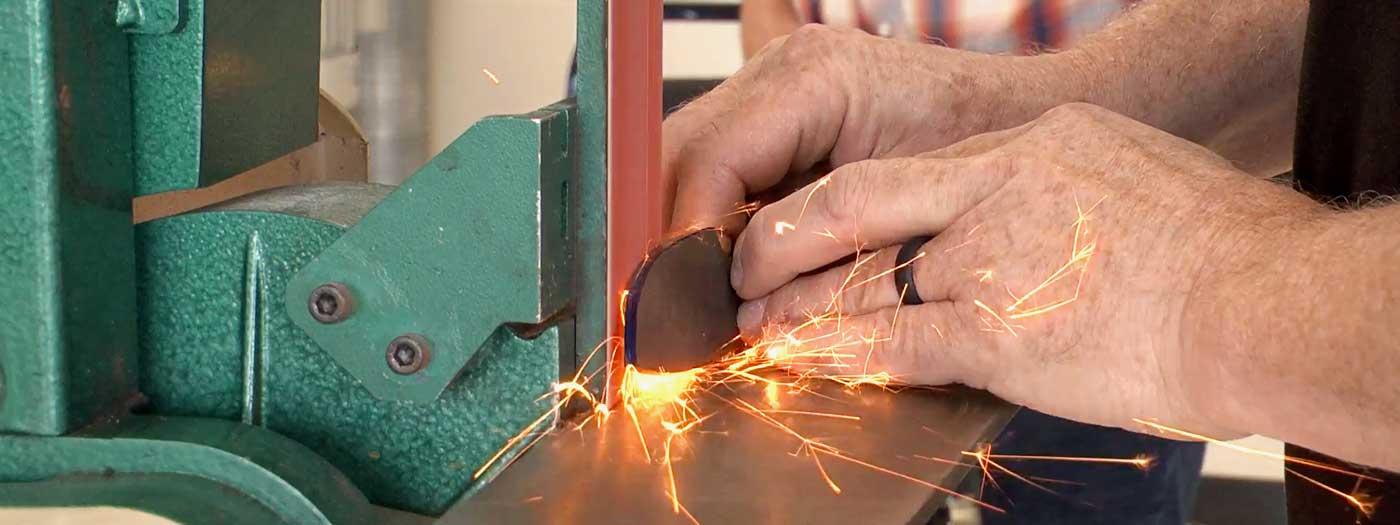 a close-up of a knife-grinding demo at a Grizzly showroom event